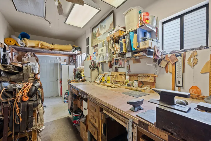 Dedicated workshop space featuring a long wooden workbench with built-in storage drawers.