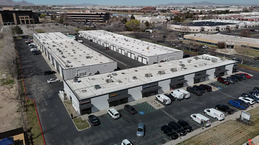 Commercial complex featuring multiple buildings with flat roofs and distinct unit entrances