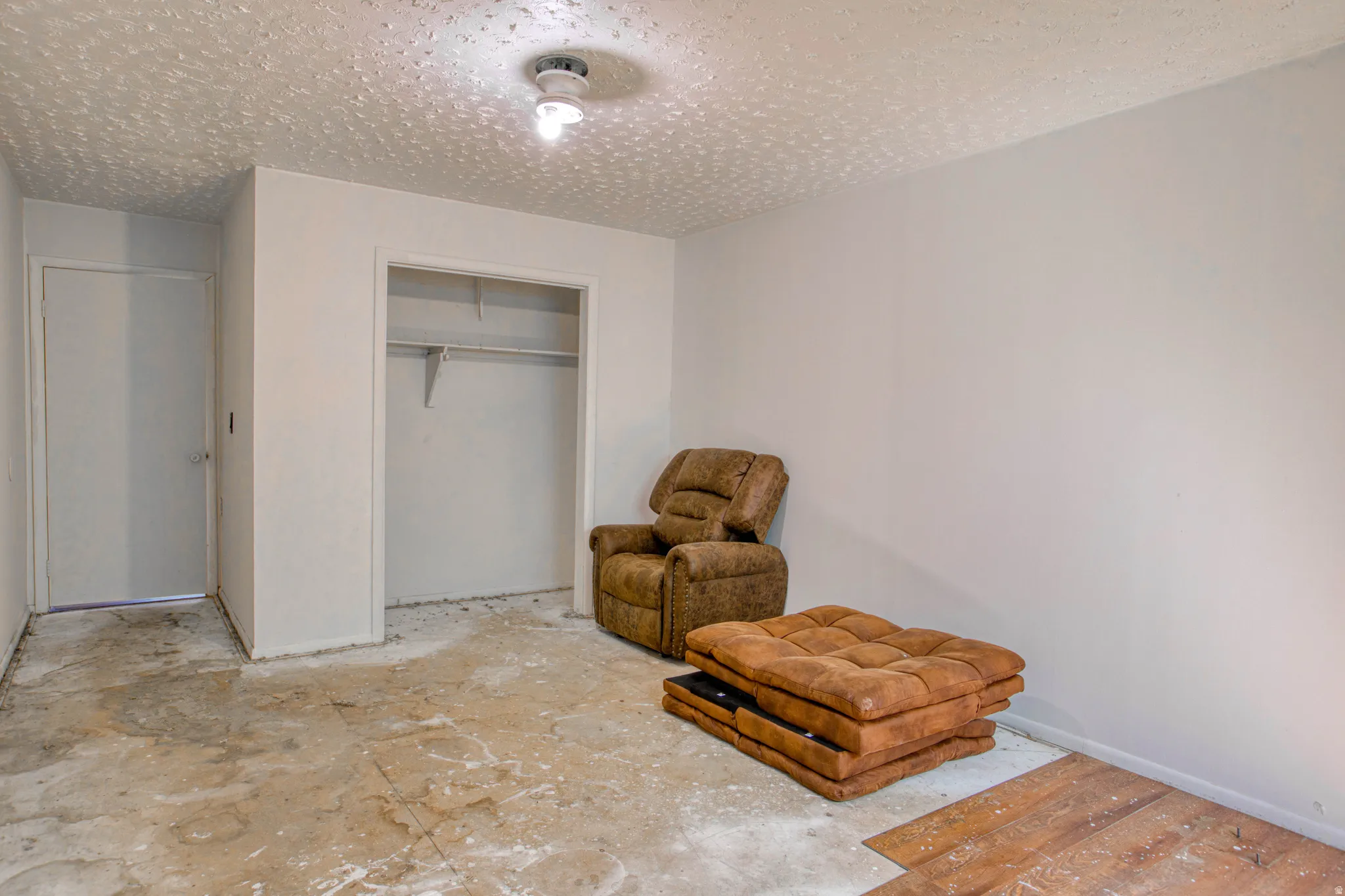 Room featuring a built-in closet with shelving and hanging rod