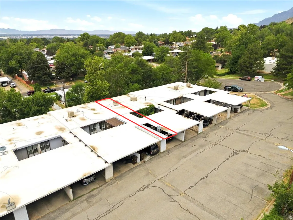Multi-unit residential structure featuring individual covered parking spaces