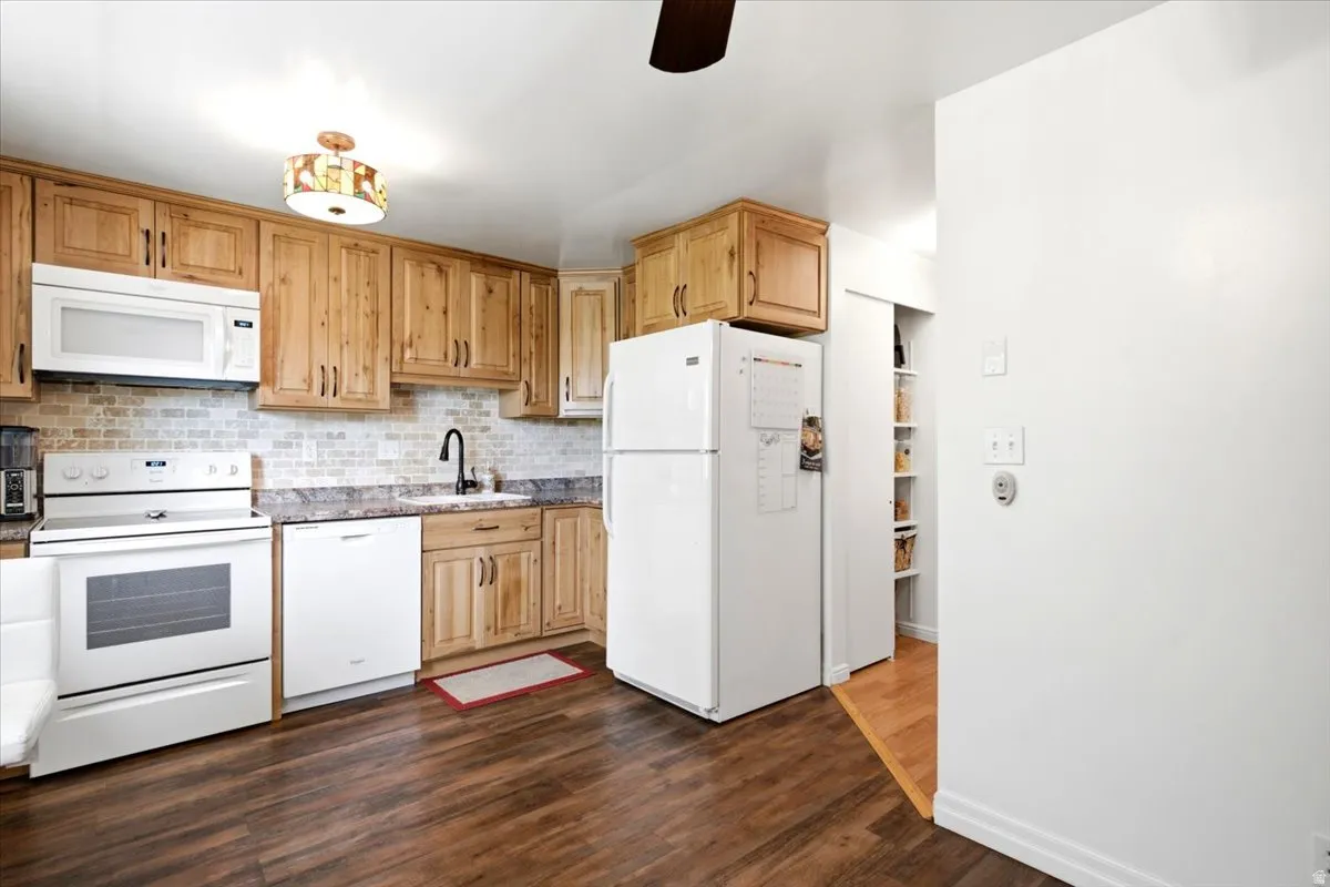 The updated kitchen features custom soft-close cabinetry and a dedicated pantry