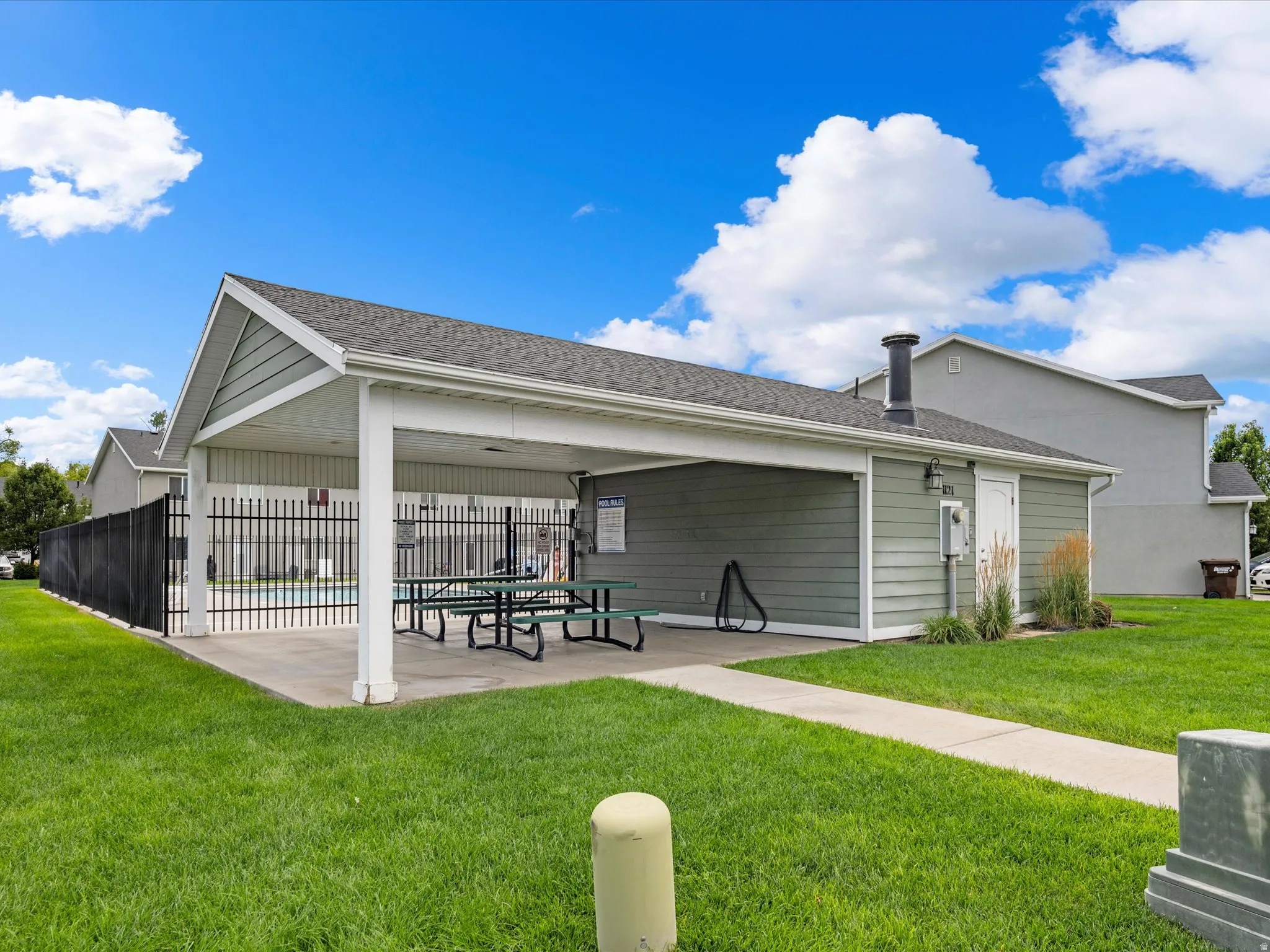 Covered patio area with concrete flooring, siding exterior, and a built-in outdoor lighting fixture