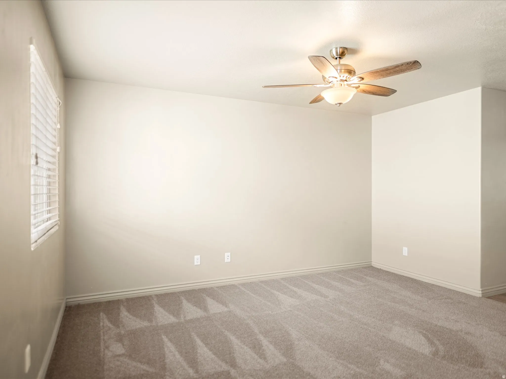 Room with neutral wall color and light-toned carpeting