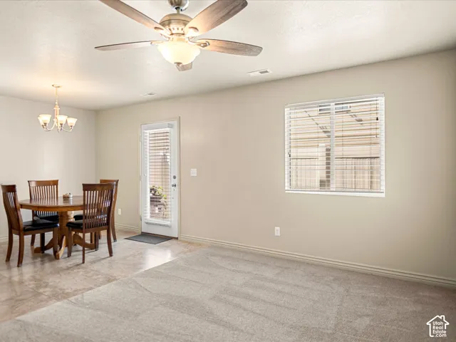 Neutral-toned walls complement the carpeted living area and tiled dining space
