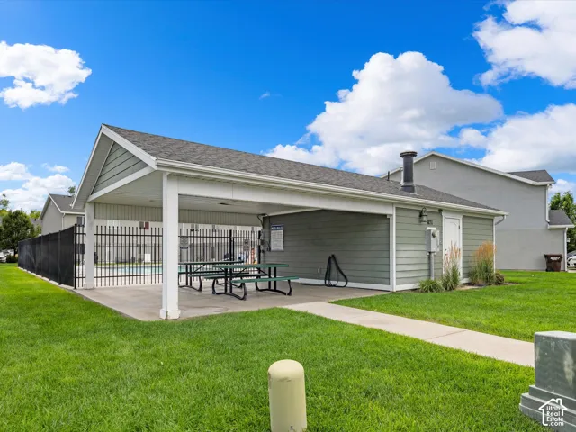 Covered patio area with concrete flooring, siding exterior, and a built-in outdoor lighting fixture