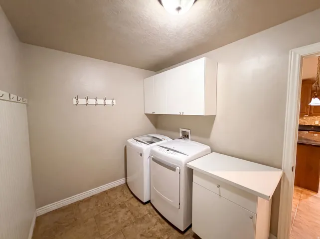 Laundry area featuring neutral wall tones and tile flooring