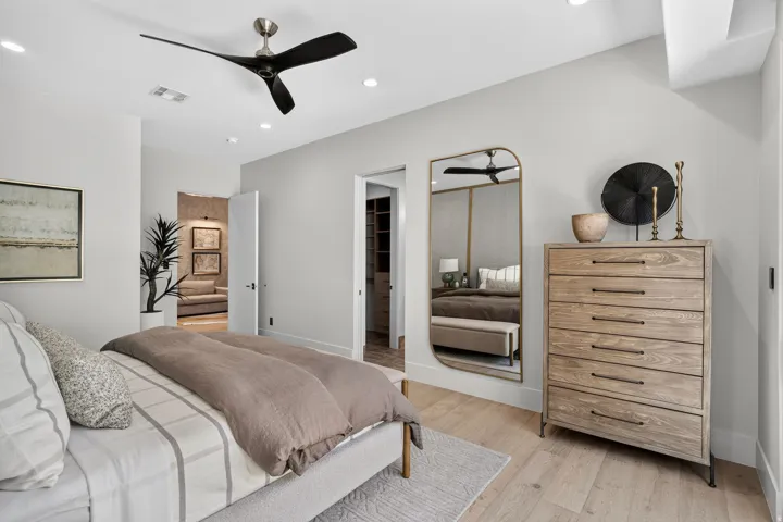 Light-toned wood-finish flooring complements the neutral wall color
