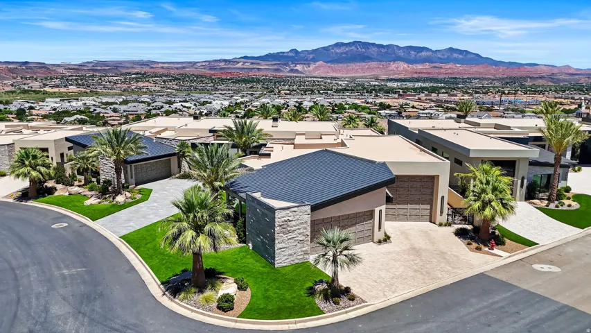 Modern exterior featuring a dark metal roof and light stone accents