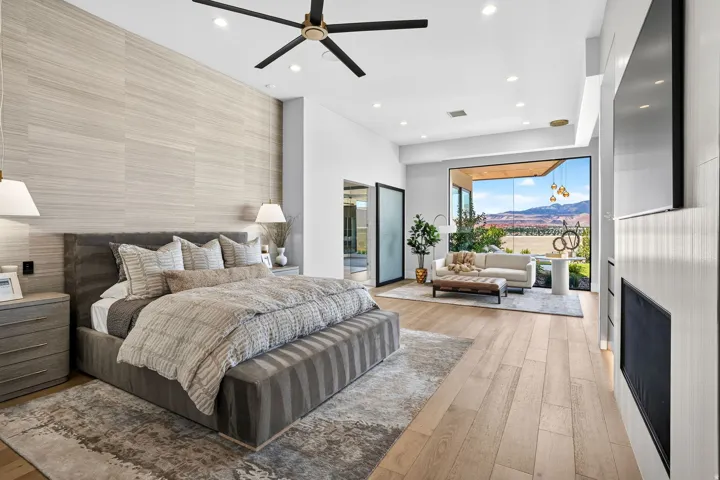 Spacious interior featuring wood-finish flooring, a contemporary ceiling fan, and recessed lighting