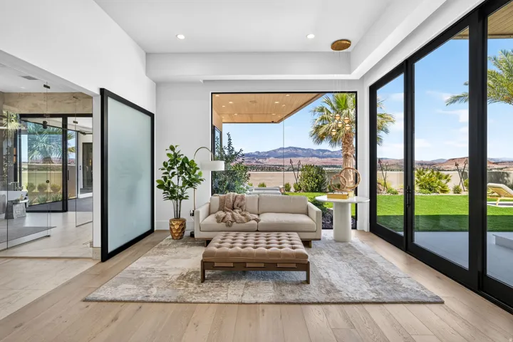Light wood-finish flooring complements white walls in this living space