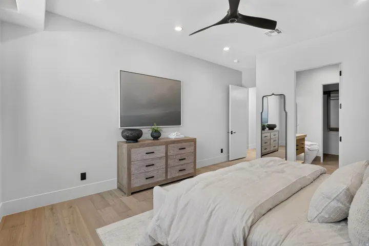 Light wood-finish flooring complements the neutral wall tones
