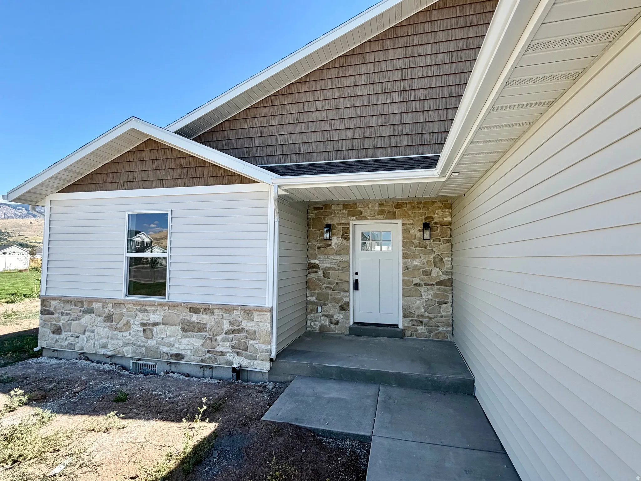 Contemporary exterior featuring stone veneer and horizontal siding