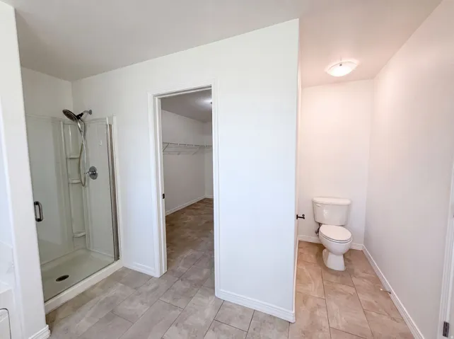 Shower with clear glass enclosure and chrome fixtures