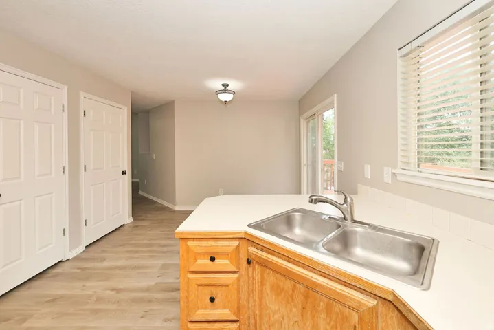 Kitchen counter with double-basin stainless steel sink and chrome faucet