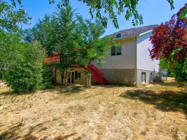 Exterior siding home with a red-painted deck and matching staircase