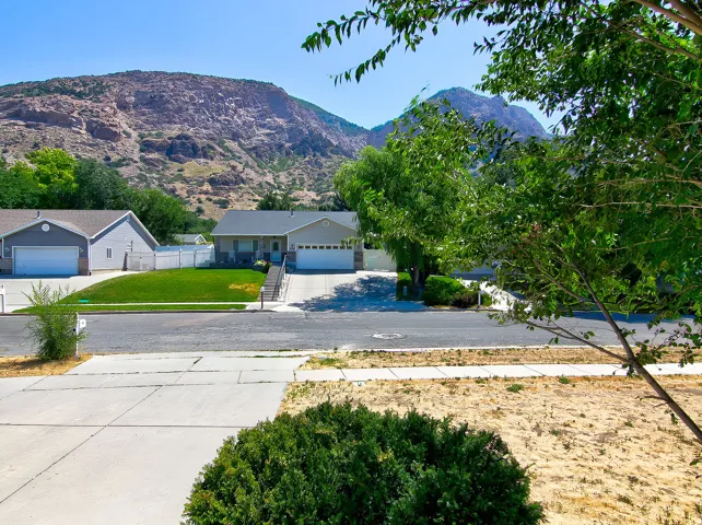 Ranch-style residence featuring a gray exterior, white trim, and an attached two-car garage
