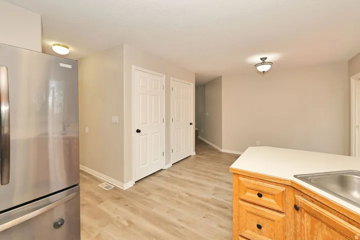 Kitchen area featuring wood-finish flooring and light gray painted walls