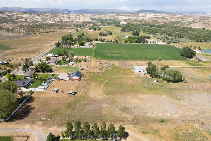 Expansive property featuring a mix of cultivated fields and open land