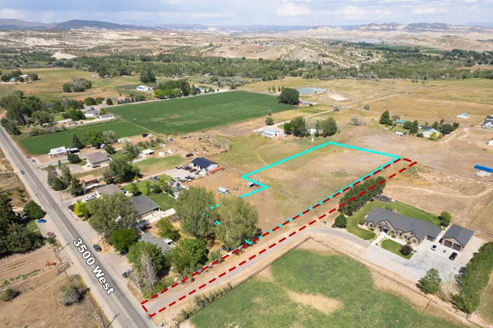 Expansive vacant land with defined property boundaries, featuring approximately 5+ acres of usable acreage