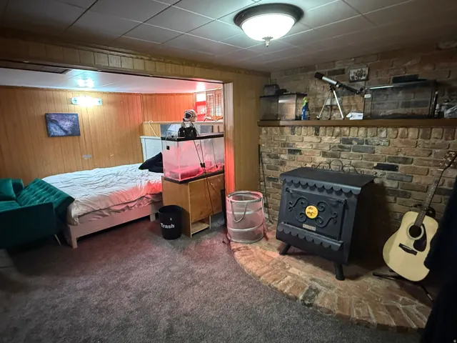 Brick hearth featuring a black cast iron stove