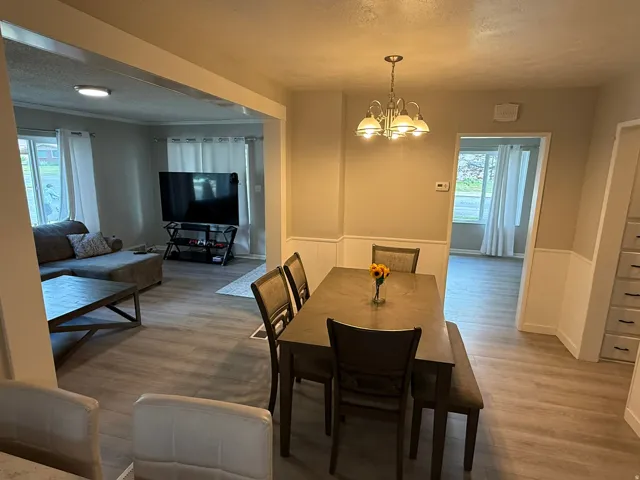 Dining area featuring a chandelier and wainscoting