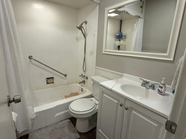 Bathroom featuring a white vanity with integrated sink, chrome faucet, and storage cabinetry
