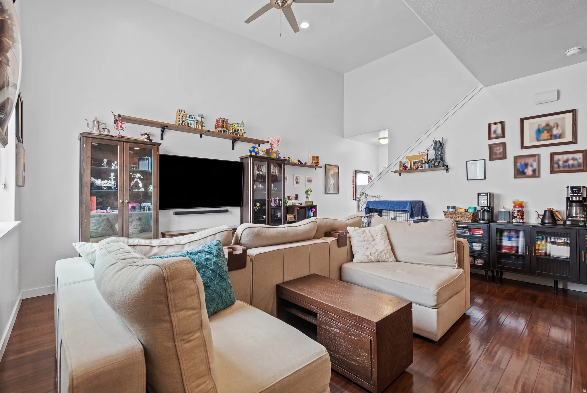 Living area with high vaulted ceilings and wood-finish flooring