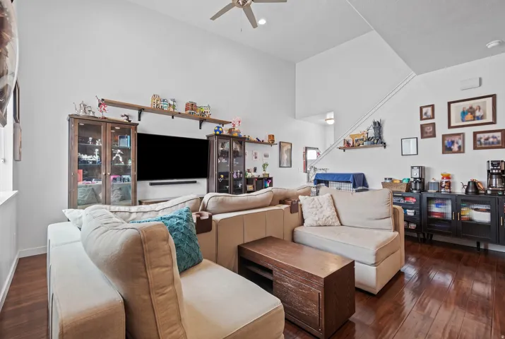Living area with high vaulted ceilings and wood-finish flooring