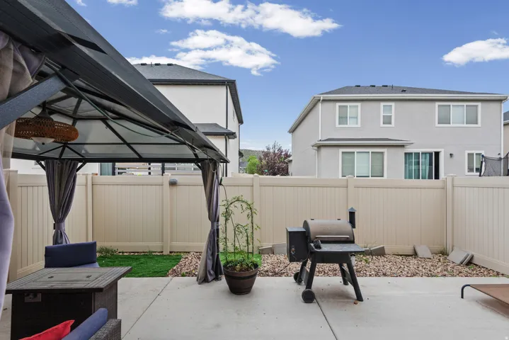 Expansive concrete patio area with a privacy fence