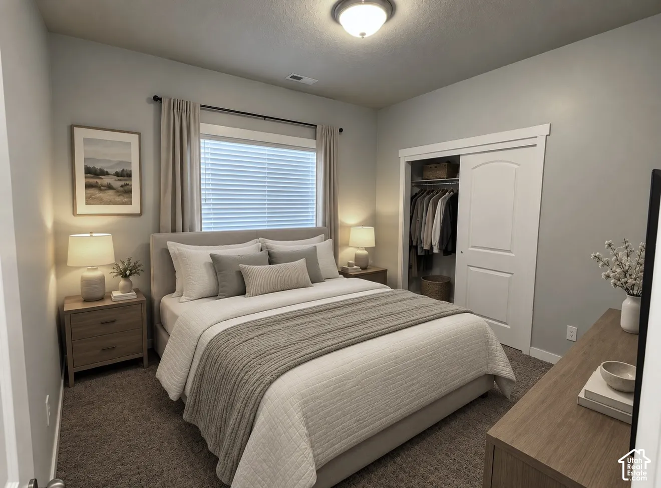 Neutral-toned walls, plush wall-to-wall carpeting, window with horizontal blinds, and a built-in closet featuring a classic arched two-panel sliding door