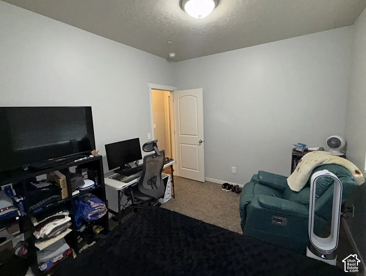 Neutral-toned walls, wall-to-wall carpeting, and a traditional-style interior door