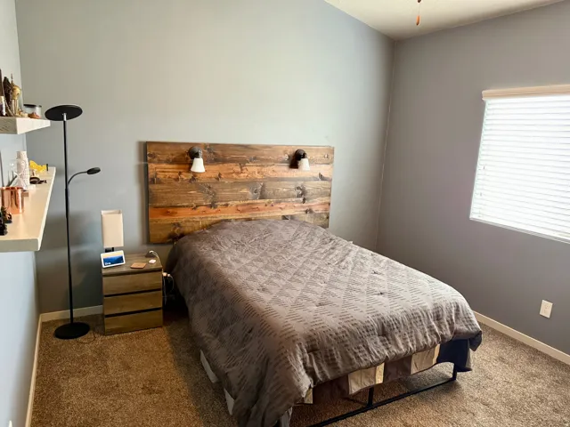 Wood-finish plank headboard with integrated sconce lighting