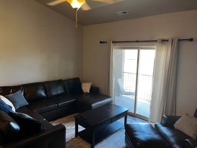 Sliding glass door opening to a private balcony with metal railings