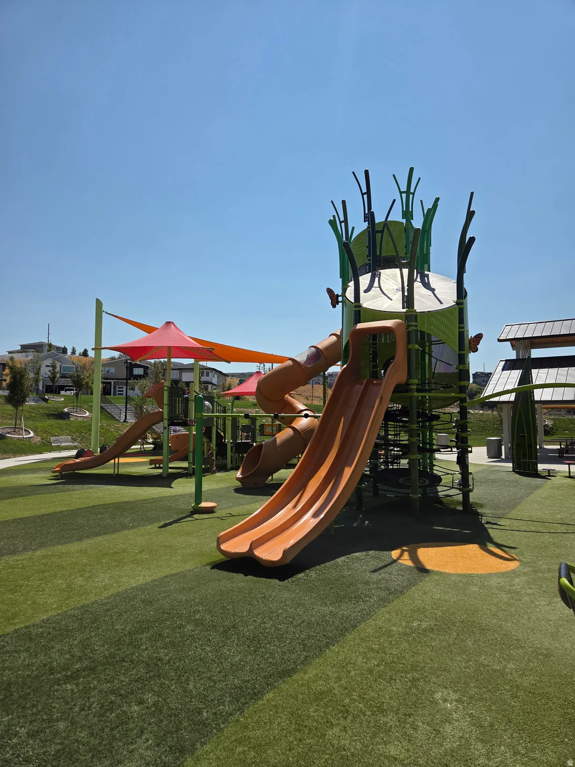 Community playground featuring artificial turf surfacing