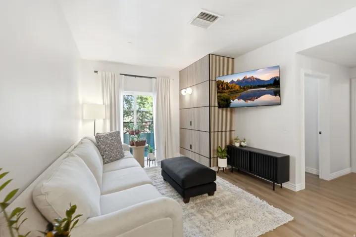 Living room with accent wall and natural light.