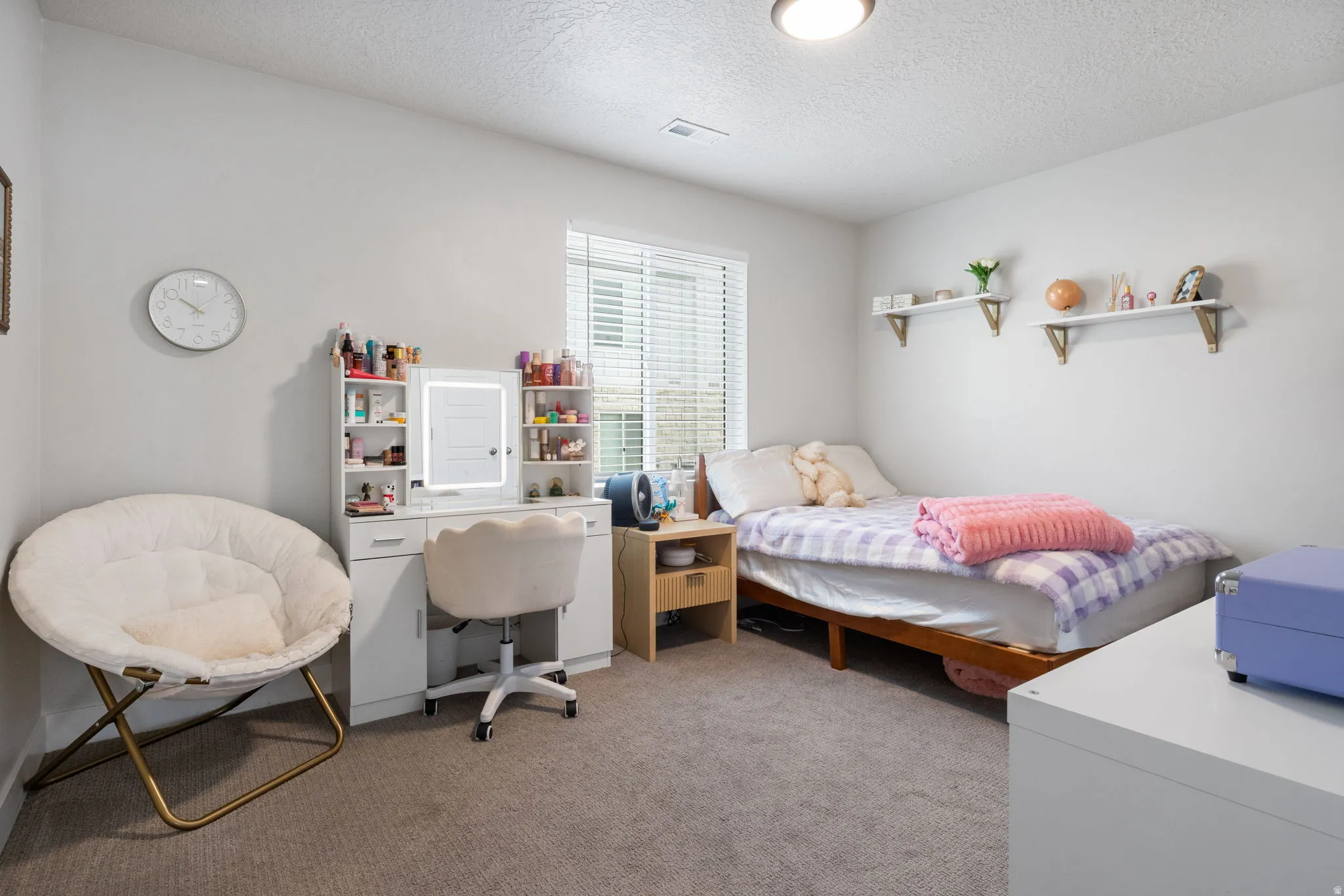 Carpeted room featuring a window with blinds, recessed ceiling light, and built-in wall shelves
