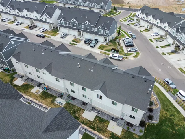 Modern townhome development featuring multi-story units with contemporary siding and dark shingle roofs