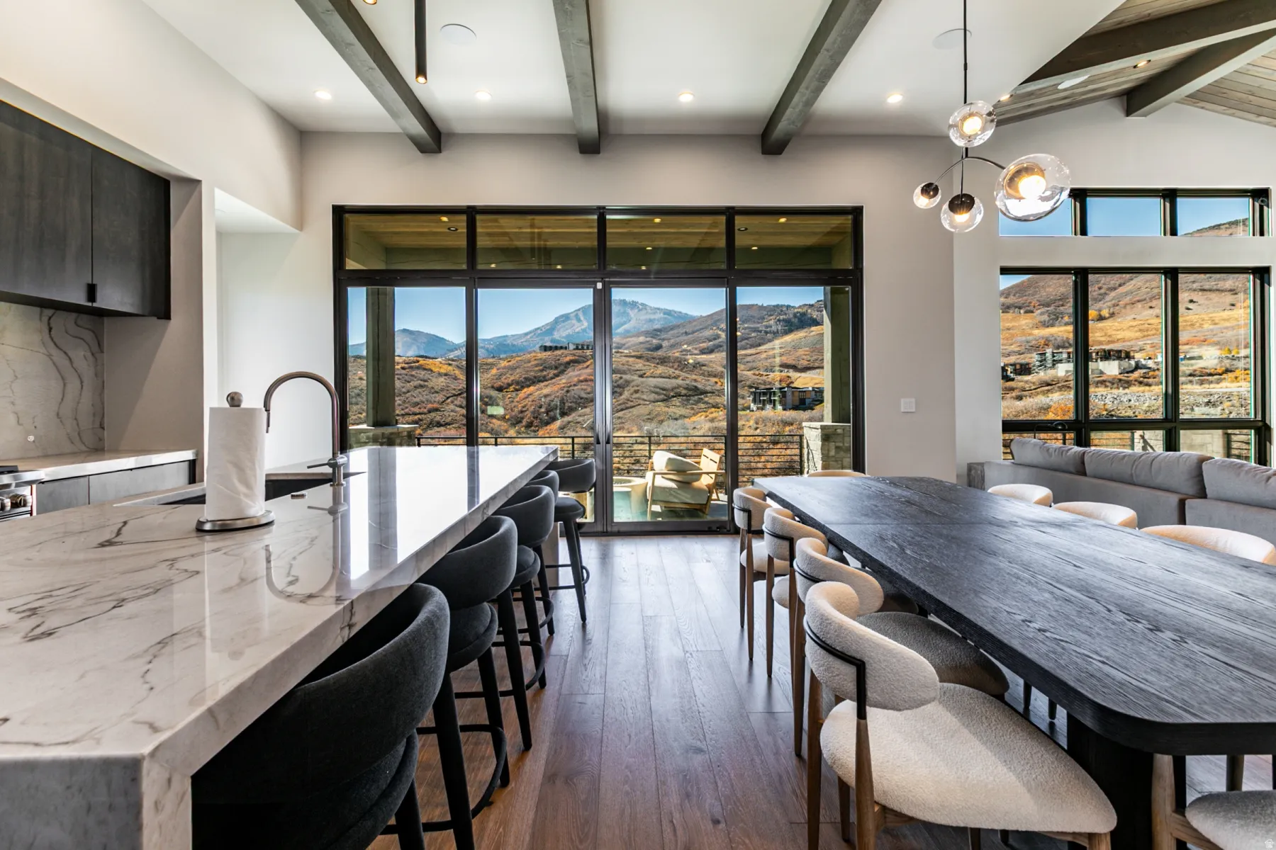 Open-concept living space featuring a gourmet kitchen island with a waterfall countertop, integrated sink, and modern faucet