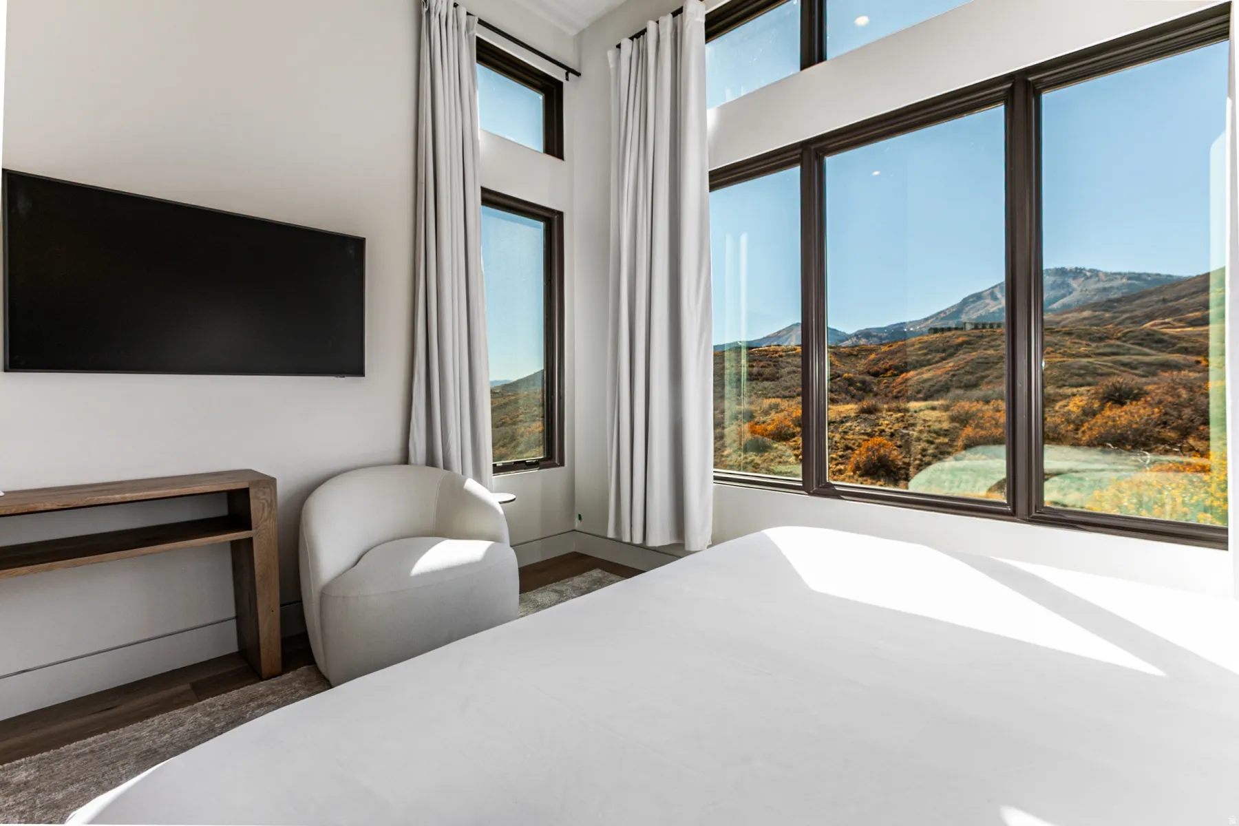 Expansive window wall with dark frames showcasing mountain scenery