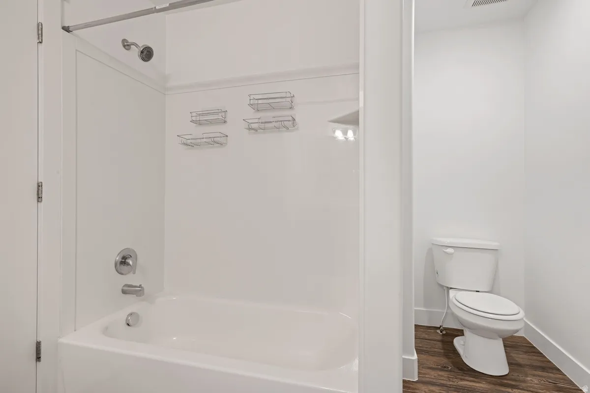Tub and shower combination with chrome fixtures and white surround