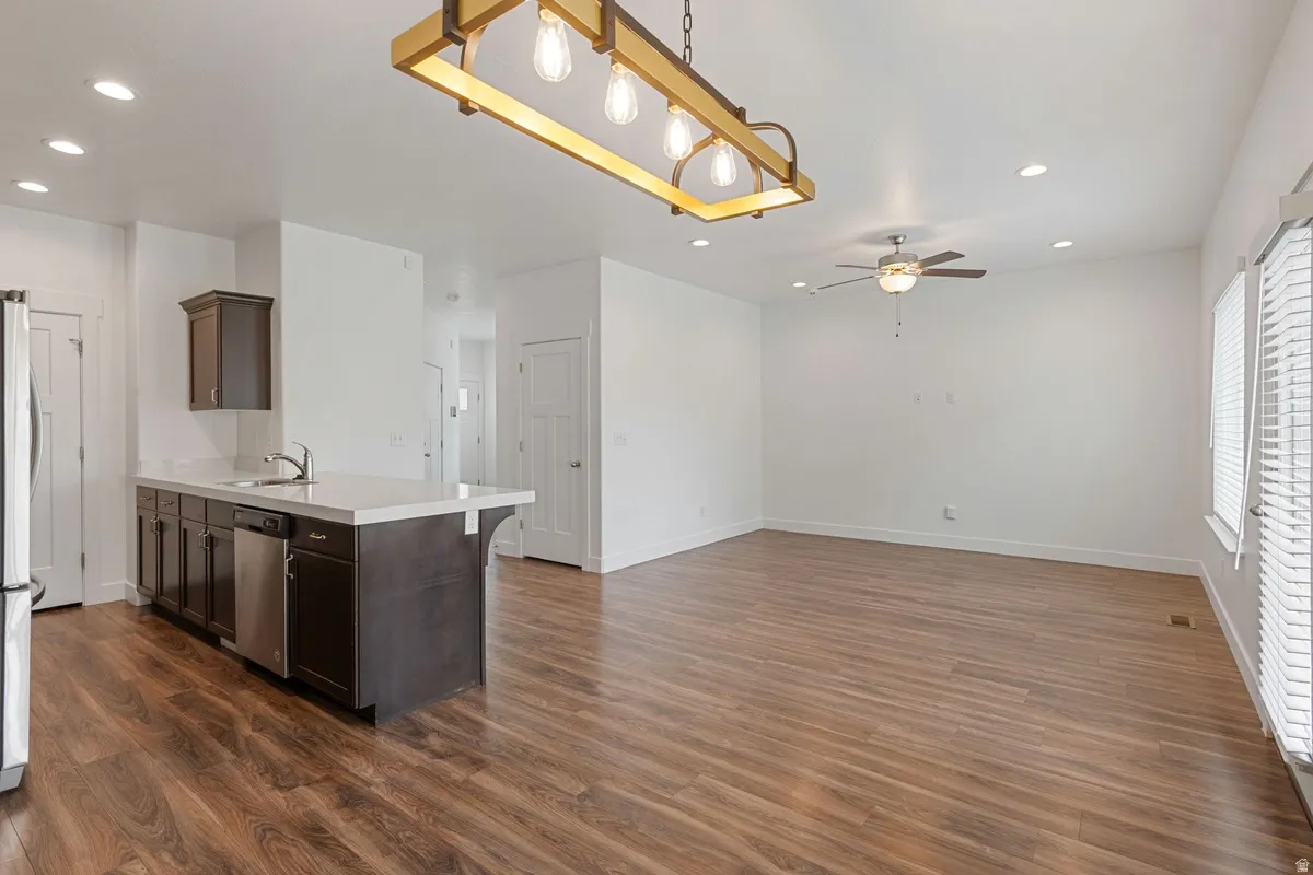 Open-concept living space featuring wood-finish flooring, recessed lighting, and a contemporary ceiling fan