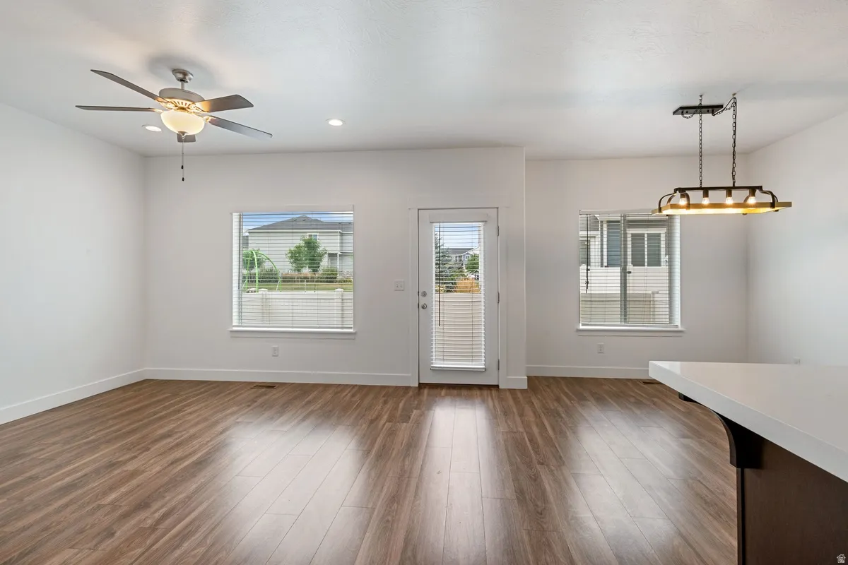 Open concept living space featuring wood-finish flooring and bright white walls