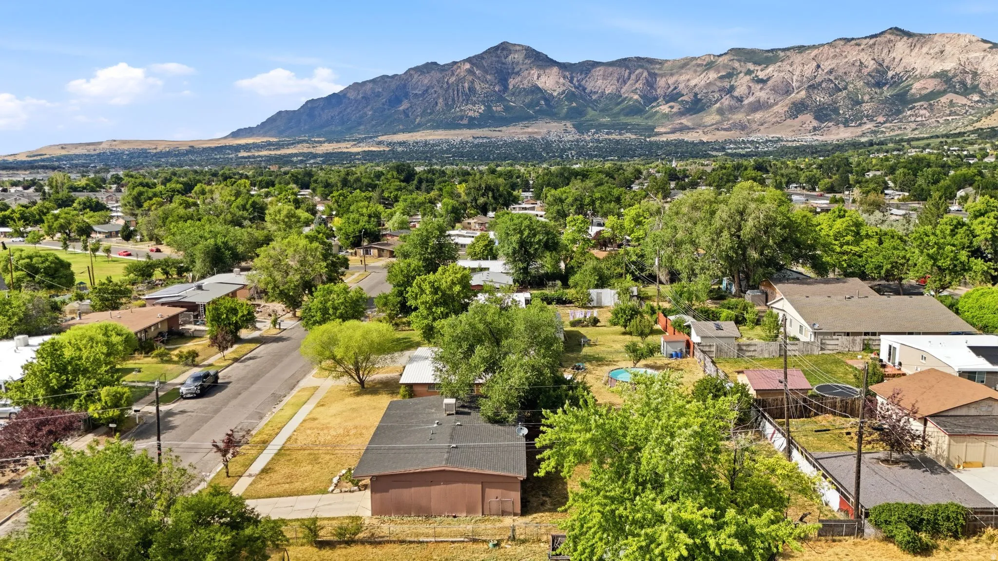 Aerial perspective showcasing a residential area with varied home styles and mature trees