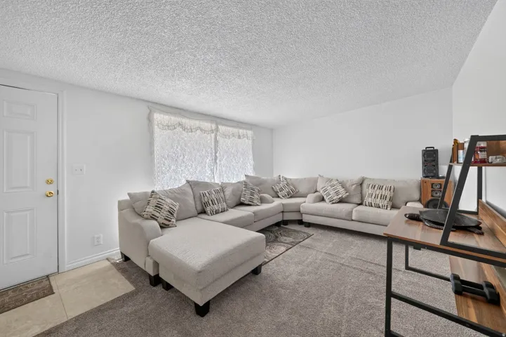 Living area featuring textured ceilings and light-colored walls