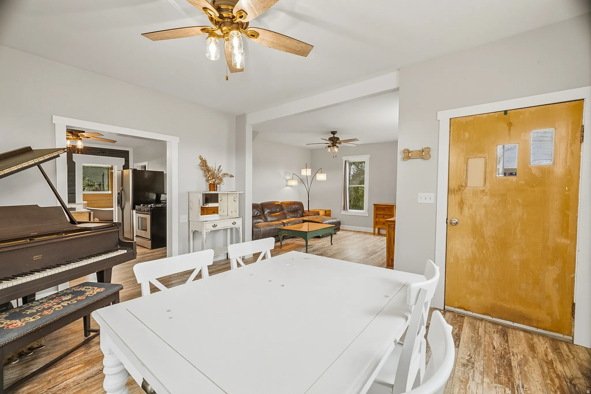 Open-concept interior featuring wood-finish flooring, light gray walls, and recessed archways