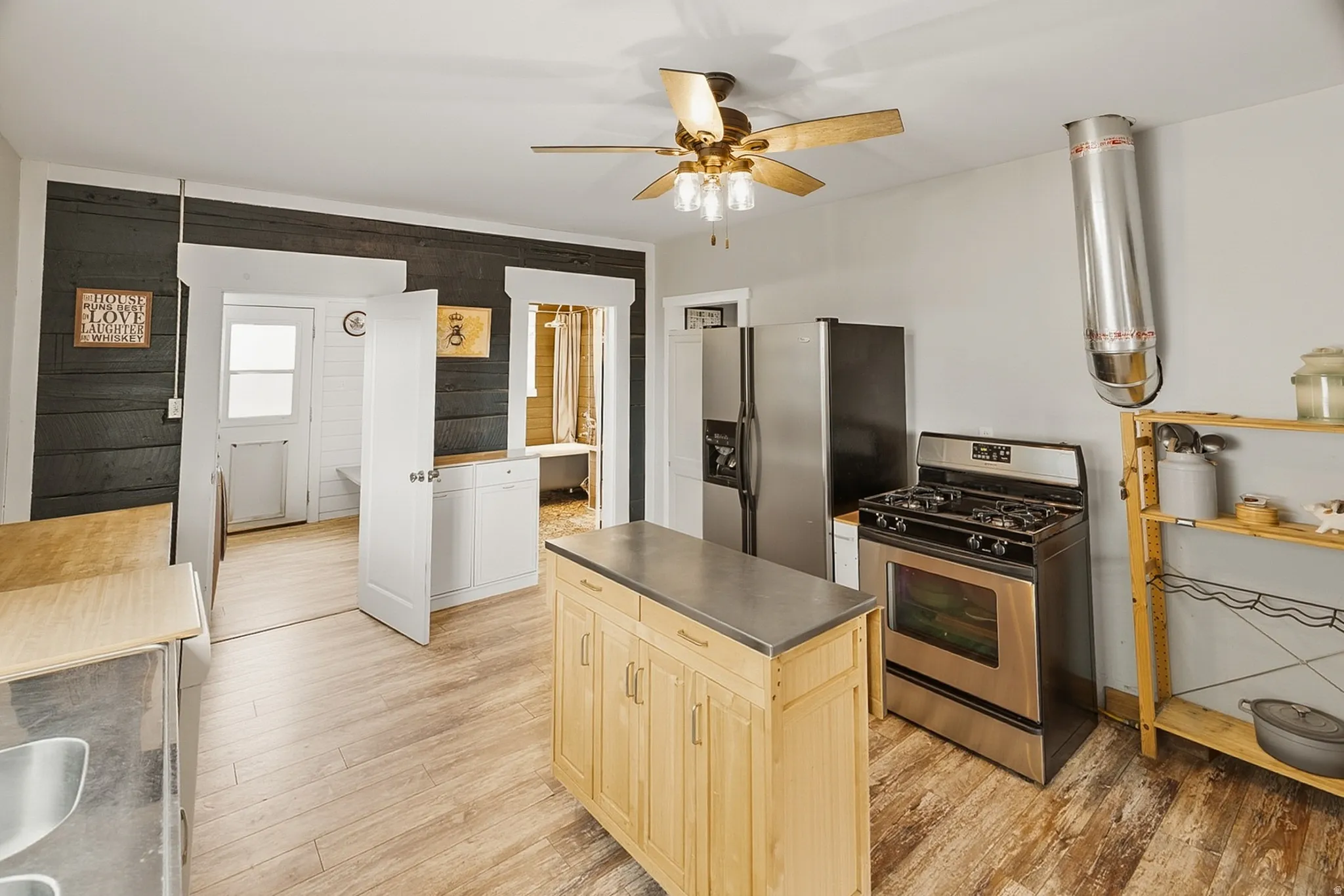 Kitchen featuring wood-finish flooring and a ceiling fan