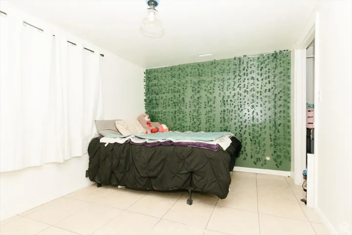 Room featuring light-toned tile flooring and white walls