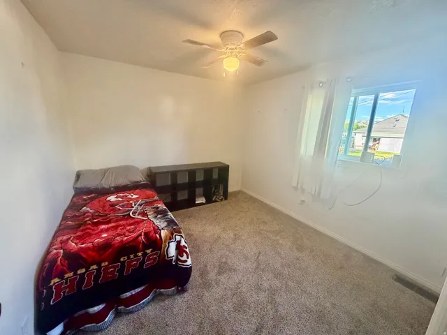 Neutral-toned carpet flooring and white painted walls provide a versatile backdrop
