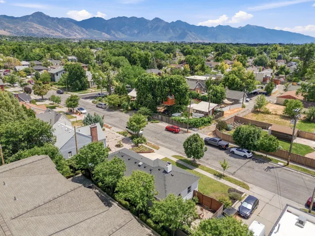 Neighborhood setting featuring mature trees and mountain scenery