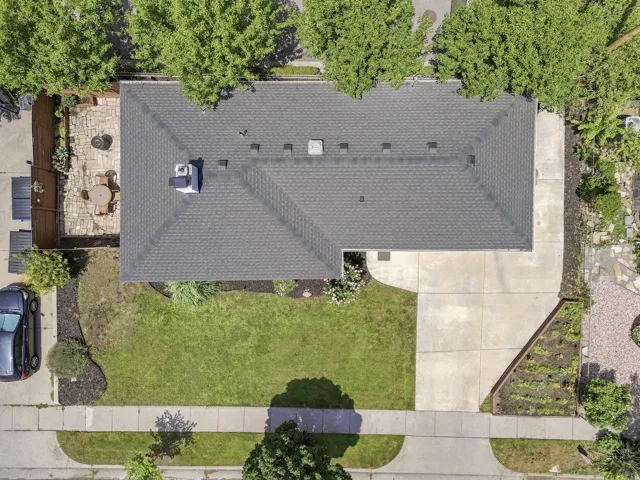 Gable roof with asphalt shingles and a central chimney
